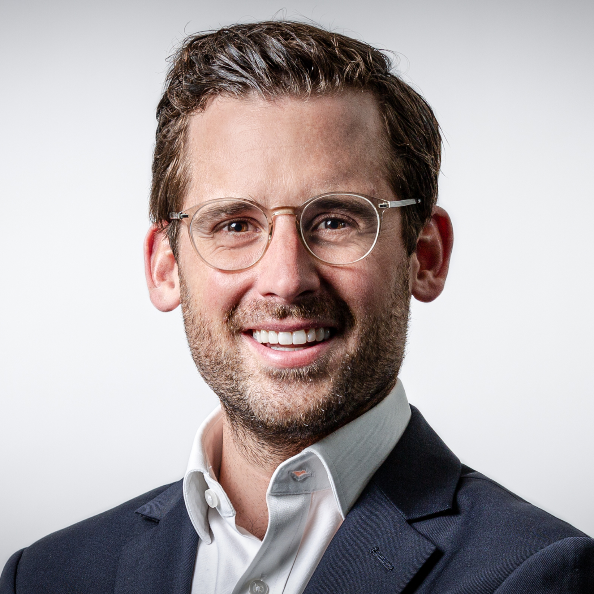 a man in a suit and glasses