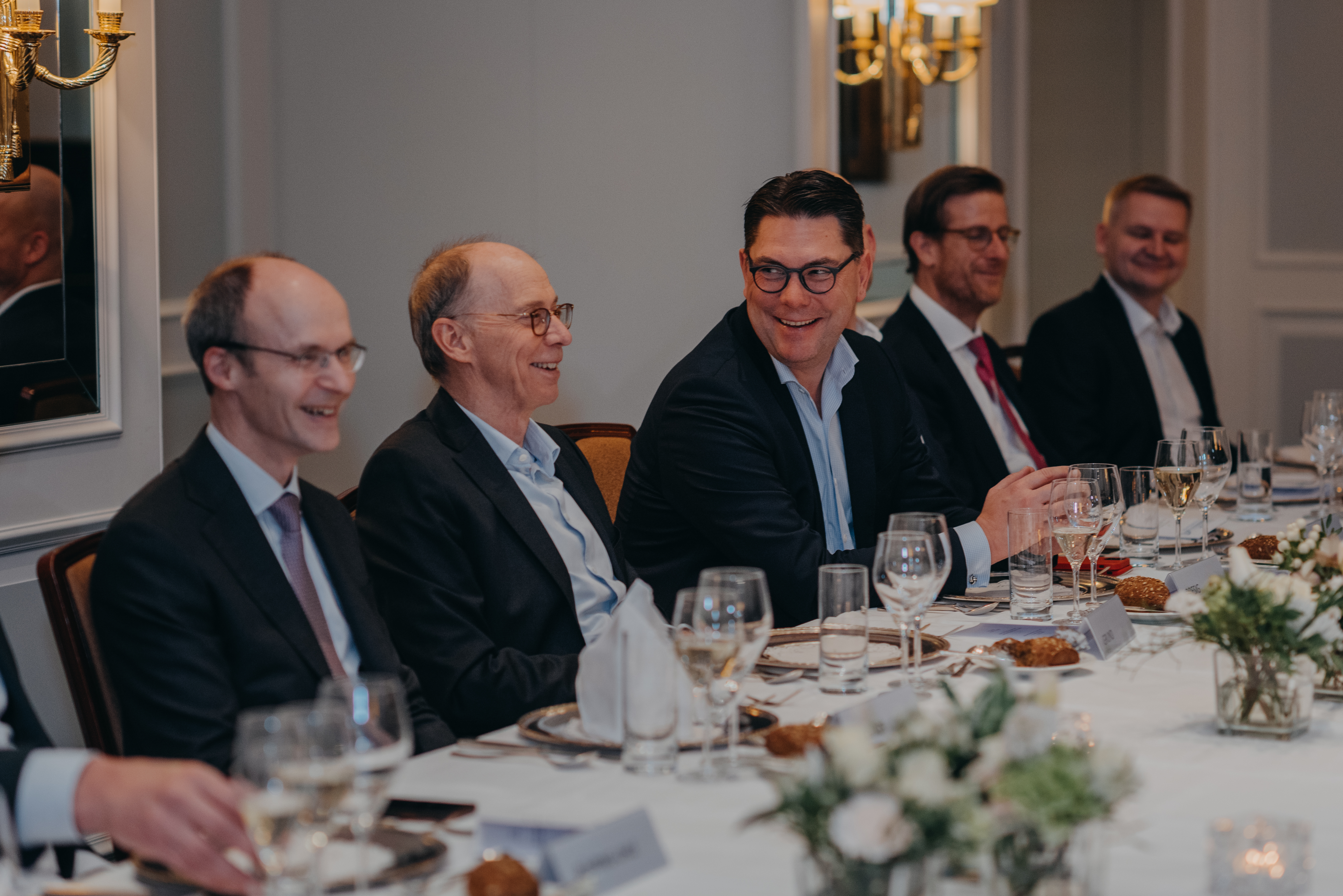 a group of men sitting at a table a group of men sitting at a table