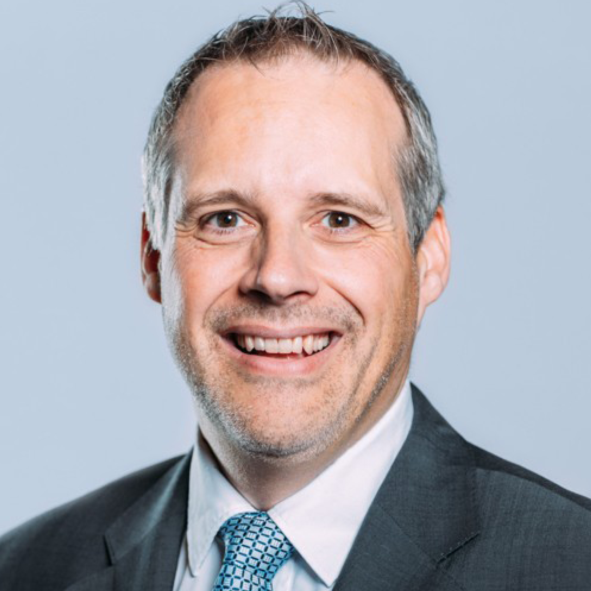 a man in a suit smiling