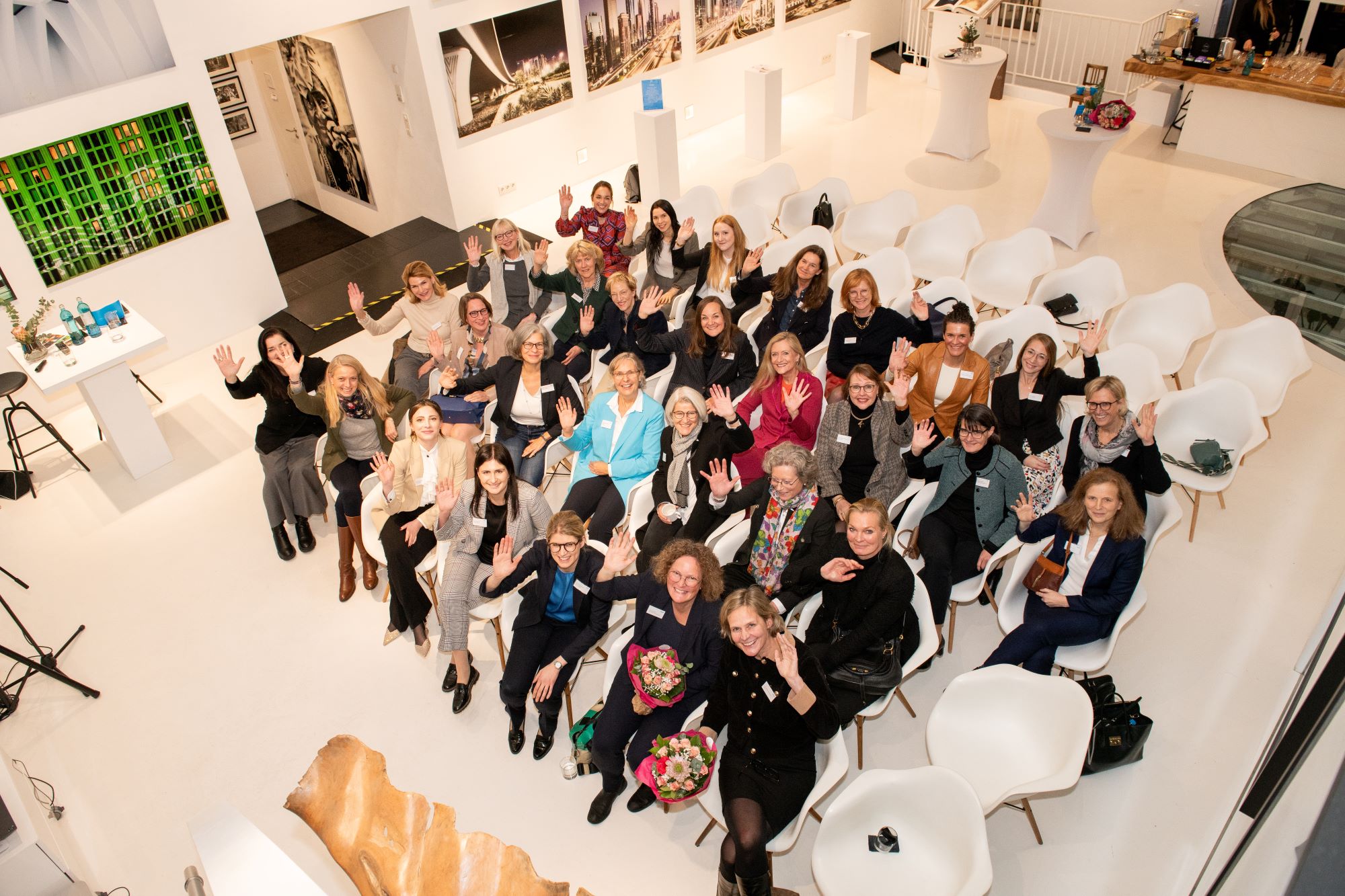 a group of people sitting in chairs a group of people sitting in chairs