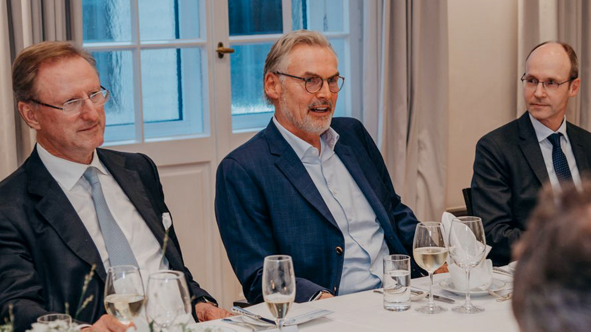 a group of men sitting at a table a group of men sitting at a table