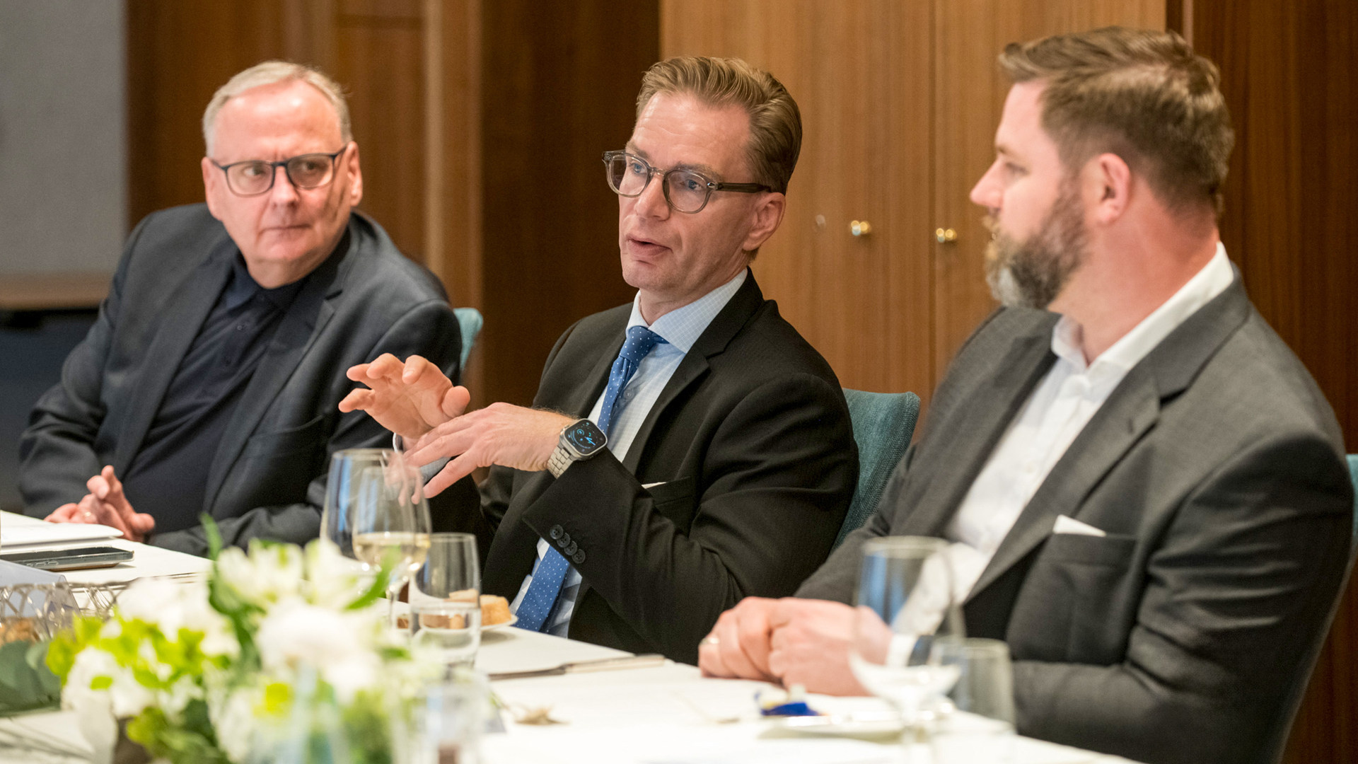 a group of men sitting at a table a group of men sitting at a table