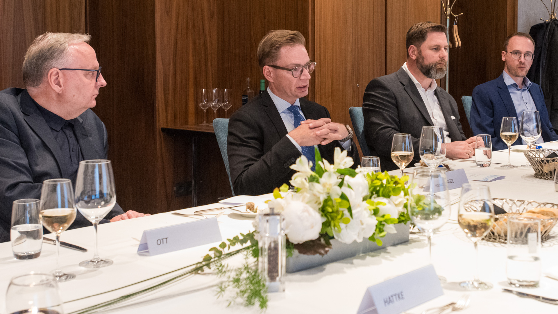 a group of men sitting at a table a group of men sitting at a table