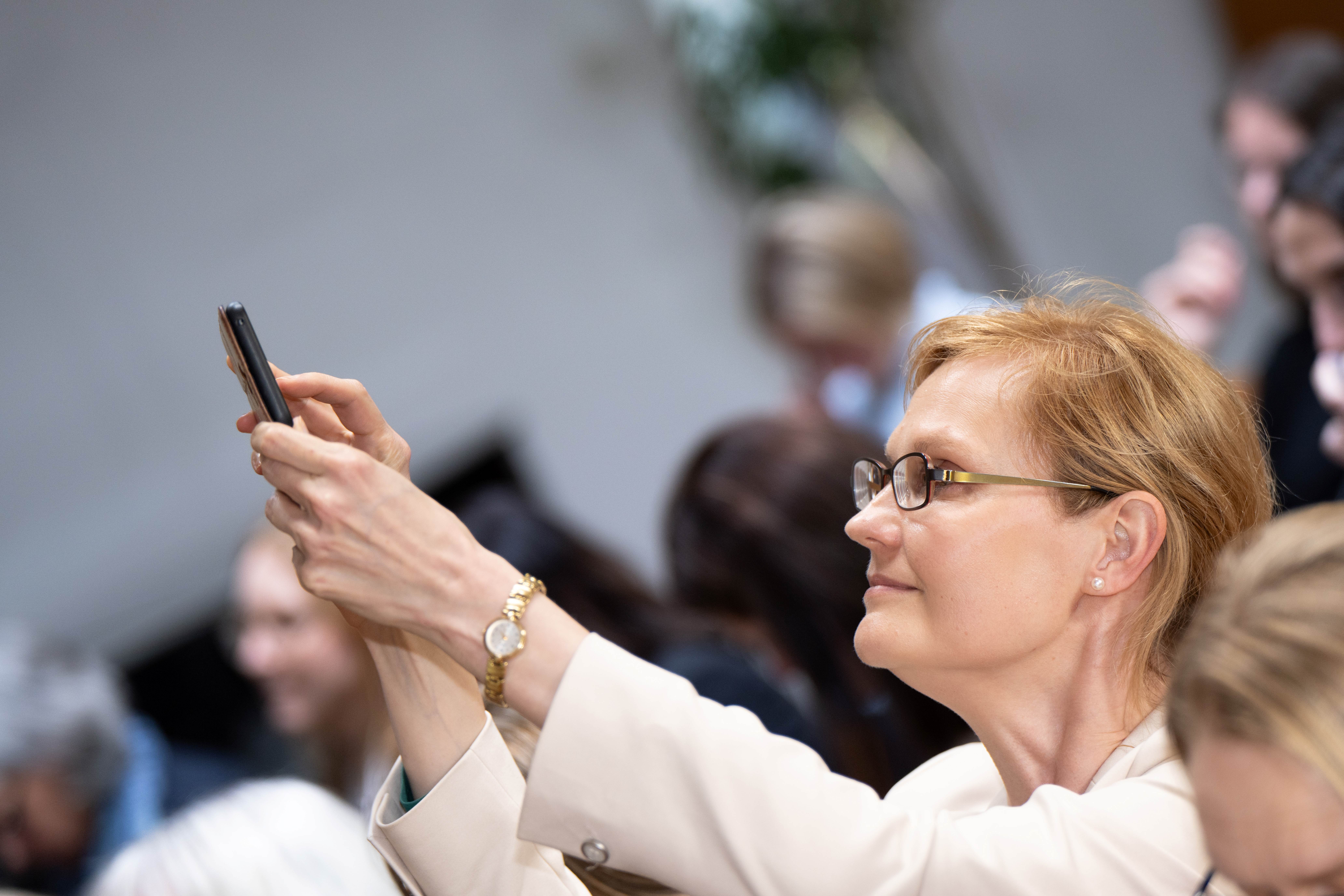 a woman holding a phone a woman holding a phone