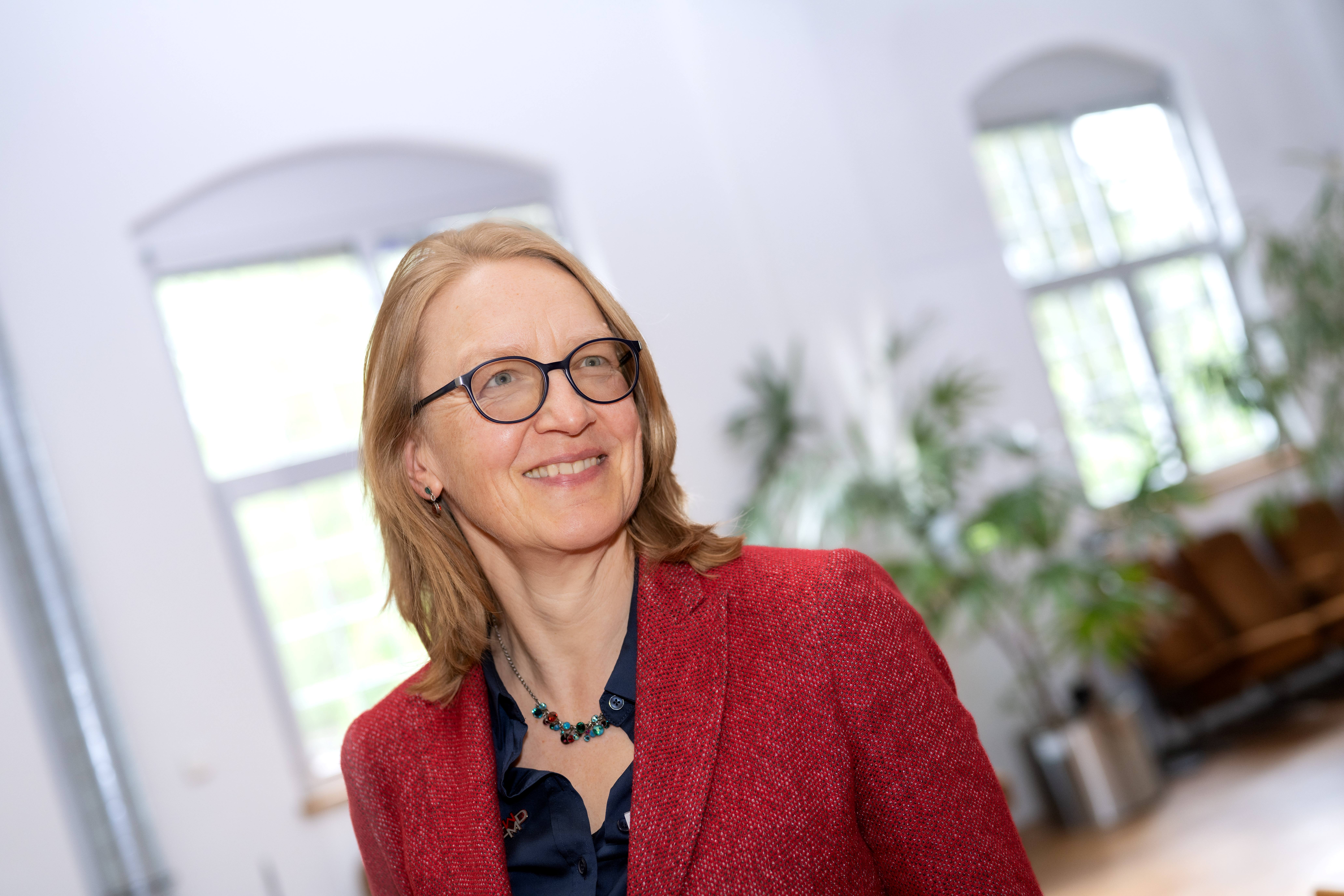 a woman wearing glasses and a red jacket a woman wearing glasses and a red jacket