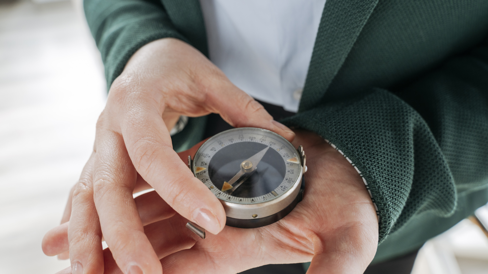 a person holding a compass a person holding a compass