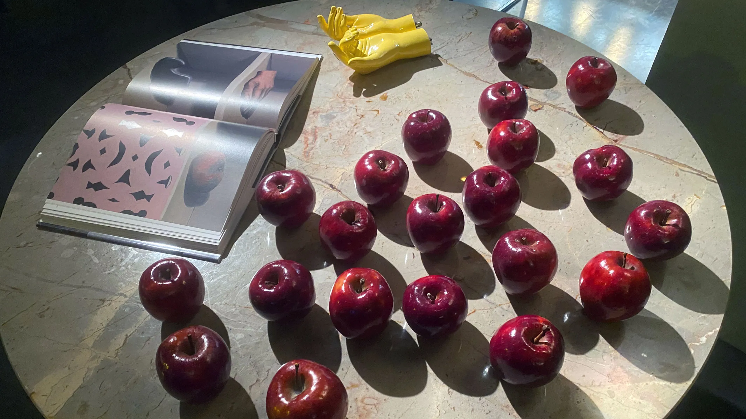 a table with apples and a book