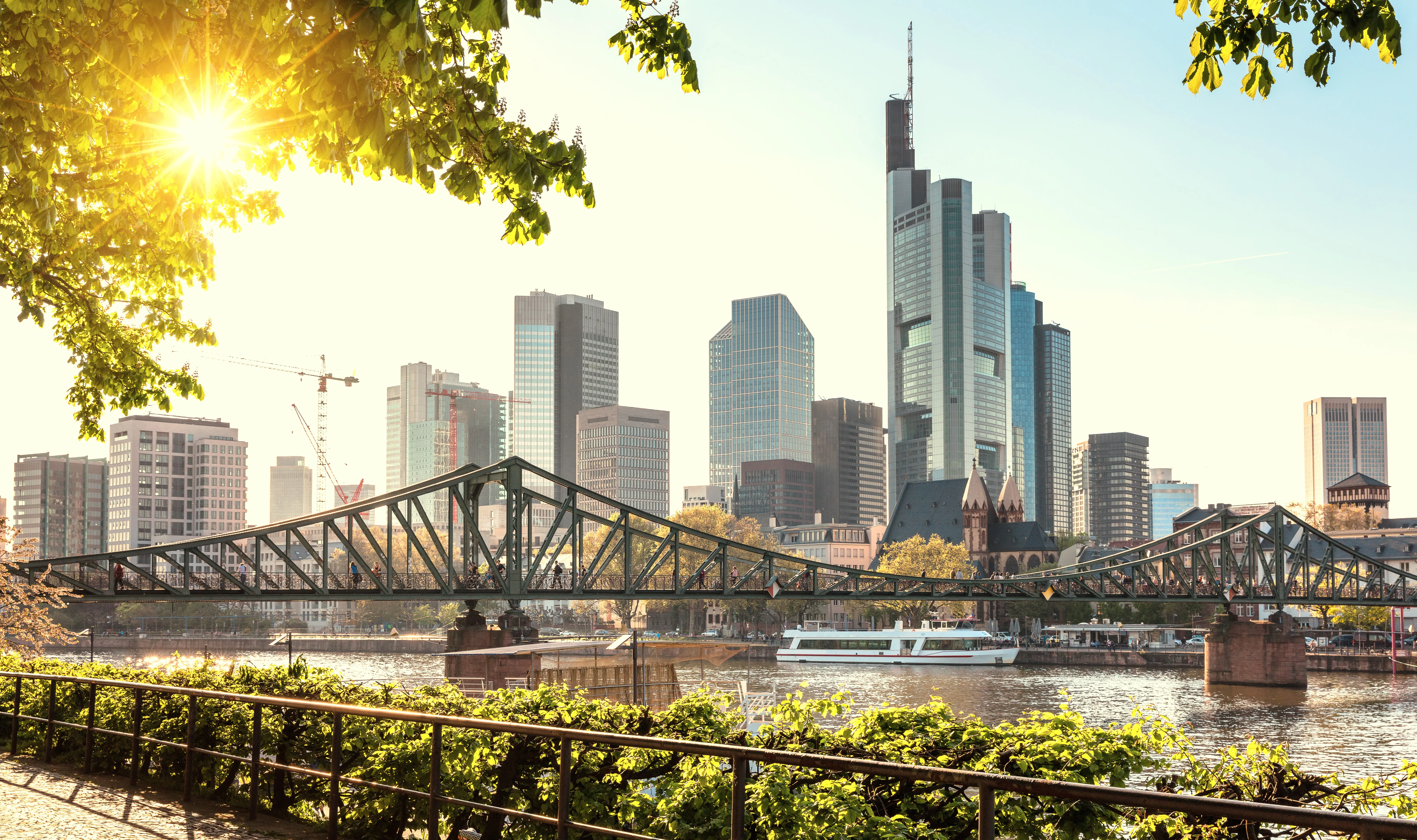 a bridge over water with a city in the background