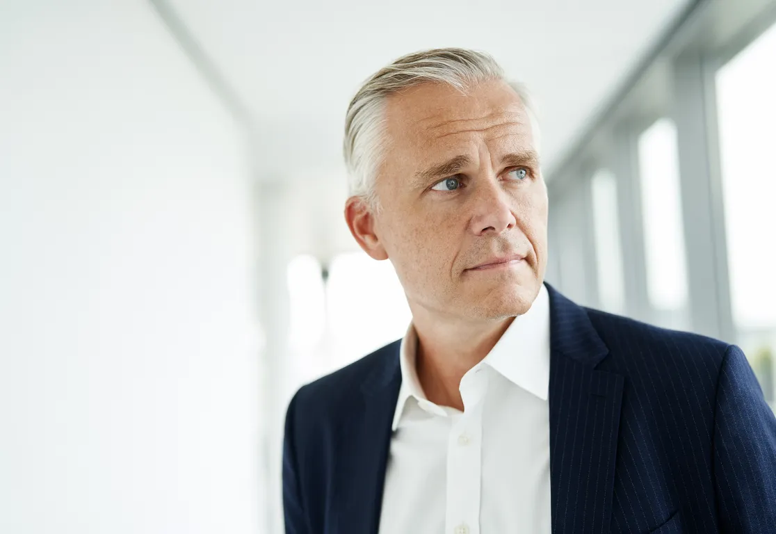 a man in a suit looking away a man in a suit looking away