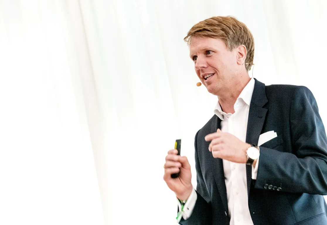 a man in a suit holding a device a man in a suit holding a device