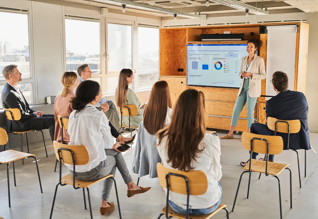 a woman standing in front of a group of people a woman standing in front of a group of people