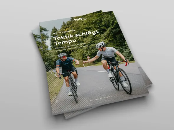 two people riding bicycles on a road