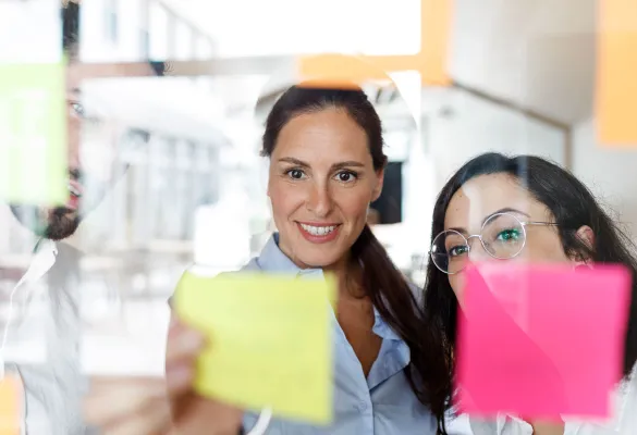 a woman holding a yellow post-it note a woman holding a yellow post-it note