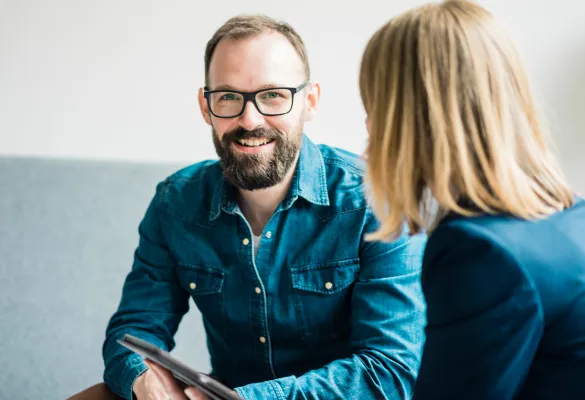 a man and woman sitting and smiling a man and woman sitting and smiling