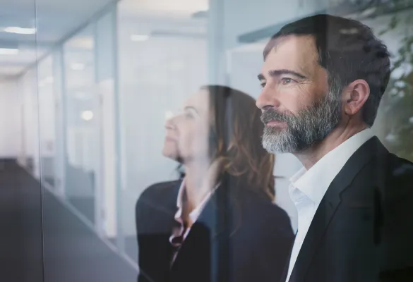 a man and woman looking out a window a man and woman looking out a window