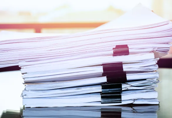 a stack of papers with binders a stack of papers with binders