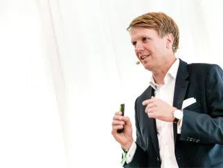 a man in a suit holding a device