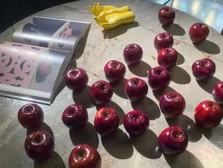 a table with apples and a book
