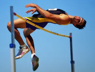 a man jumping over a bar