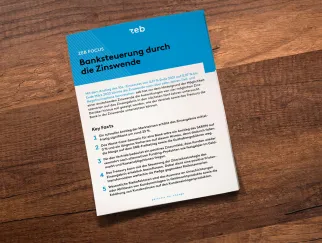 a blue and white paper on a wood surface