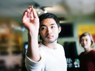 a man holding up a cigarette a man holding up a cigarette