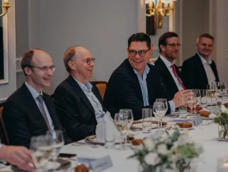 a group of men sitting at a table