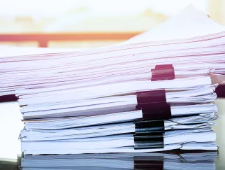 a stack of papers with binders