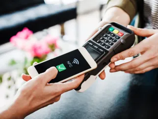a person using a phone to pay for a credit card