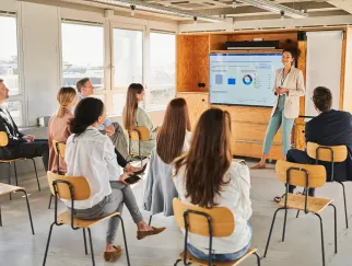 a woman standing in front of a group of people a woman standing in front of a group of people
