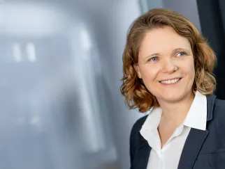 a woman smiling in a suit a woman smiling in a suit