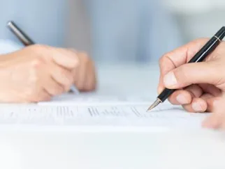 a close-up of a person holding a pen