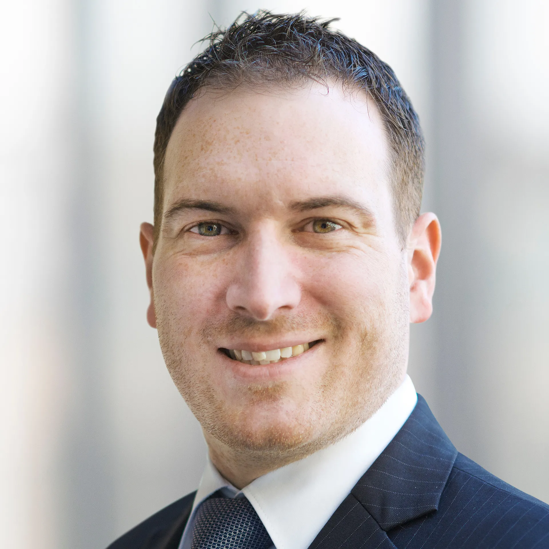 a man in a suit smiling