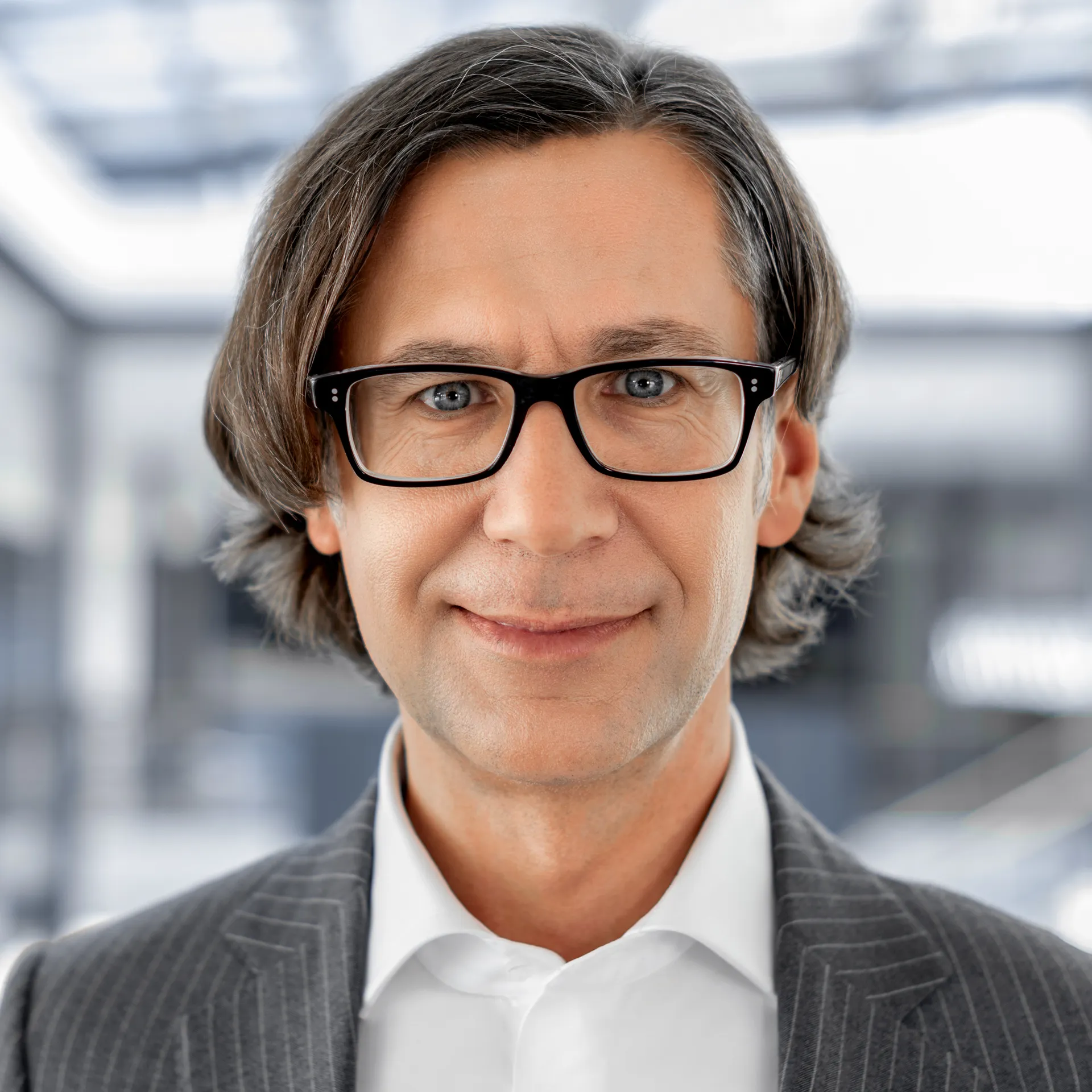 a man in a suit and glasses
