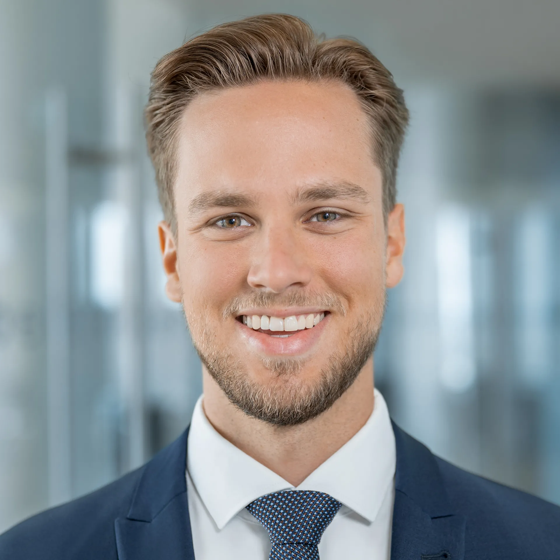 a man in a suit smiling