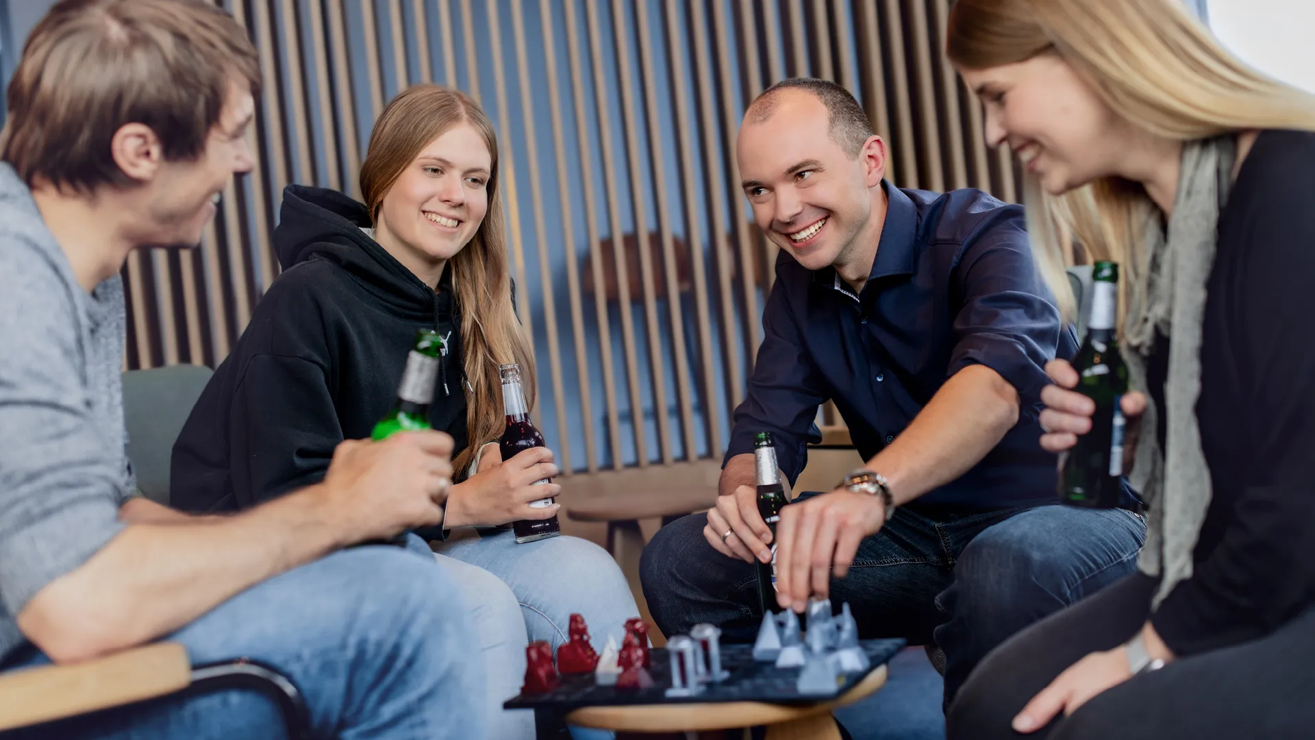 a group of people sitting around a board game