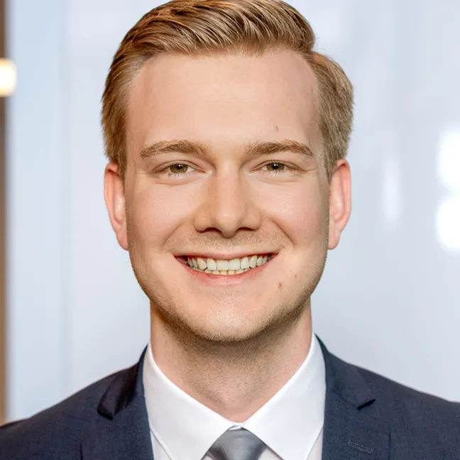 a man in a suit smiling