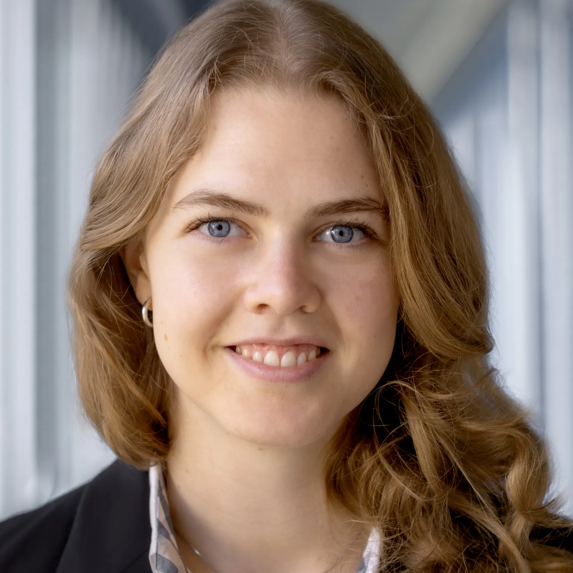 Eine Frau, die in die Kamera lächelt