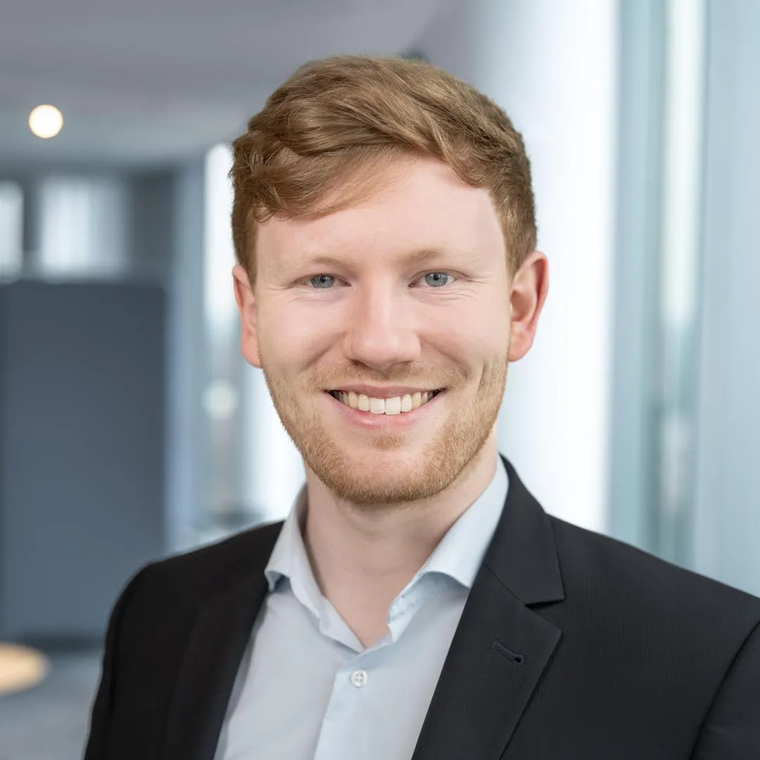 Ein Mann, der in die Kamera lächelt