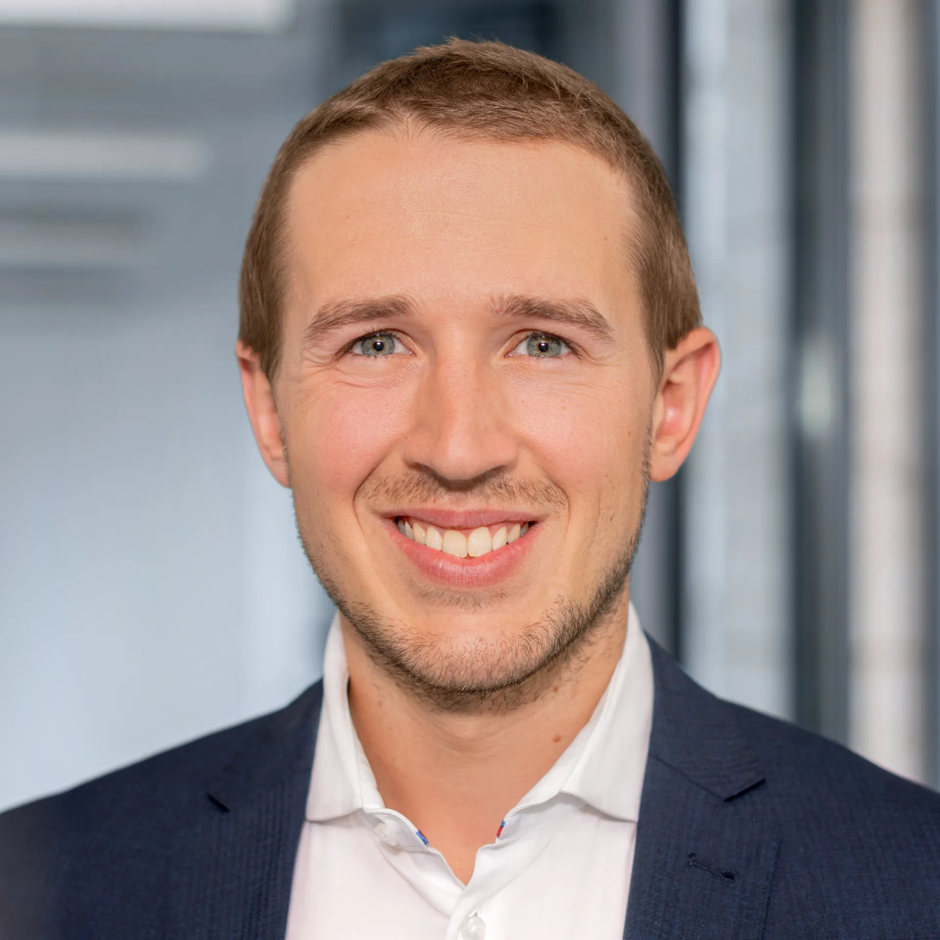a man in a suit smiling