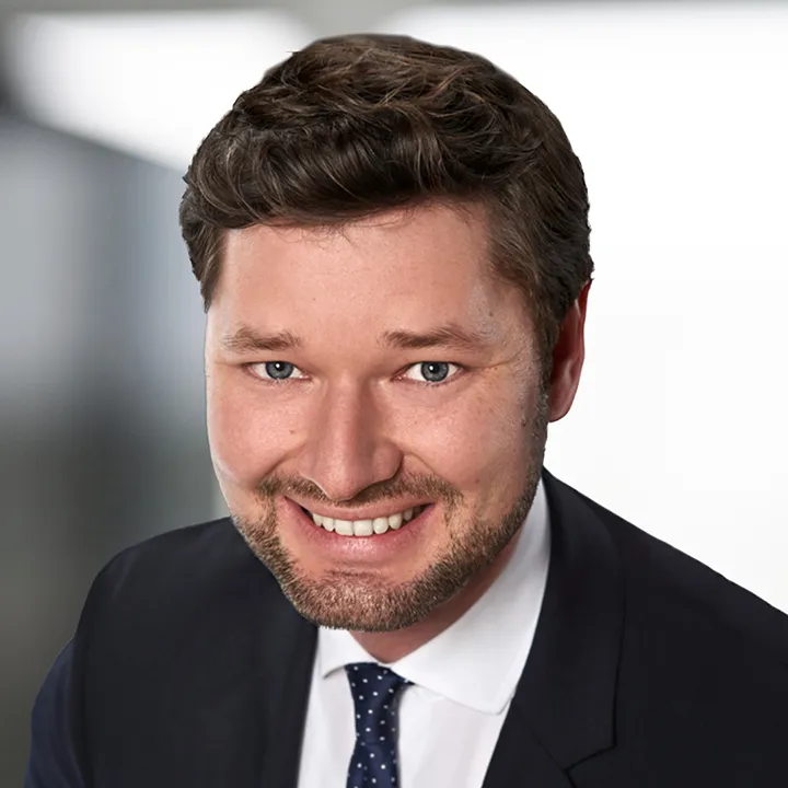 a man in a suit smiling