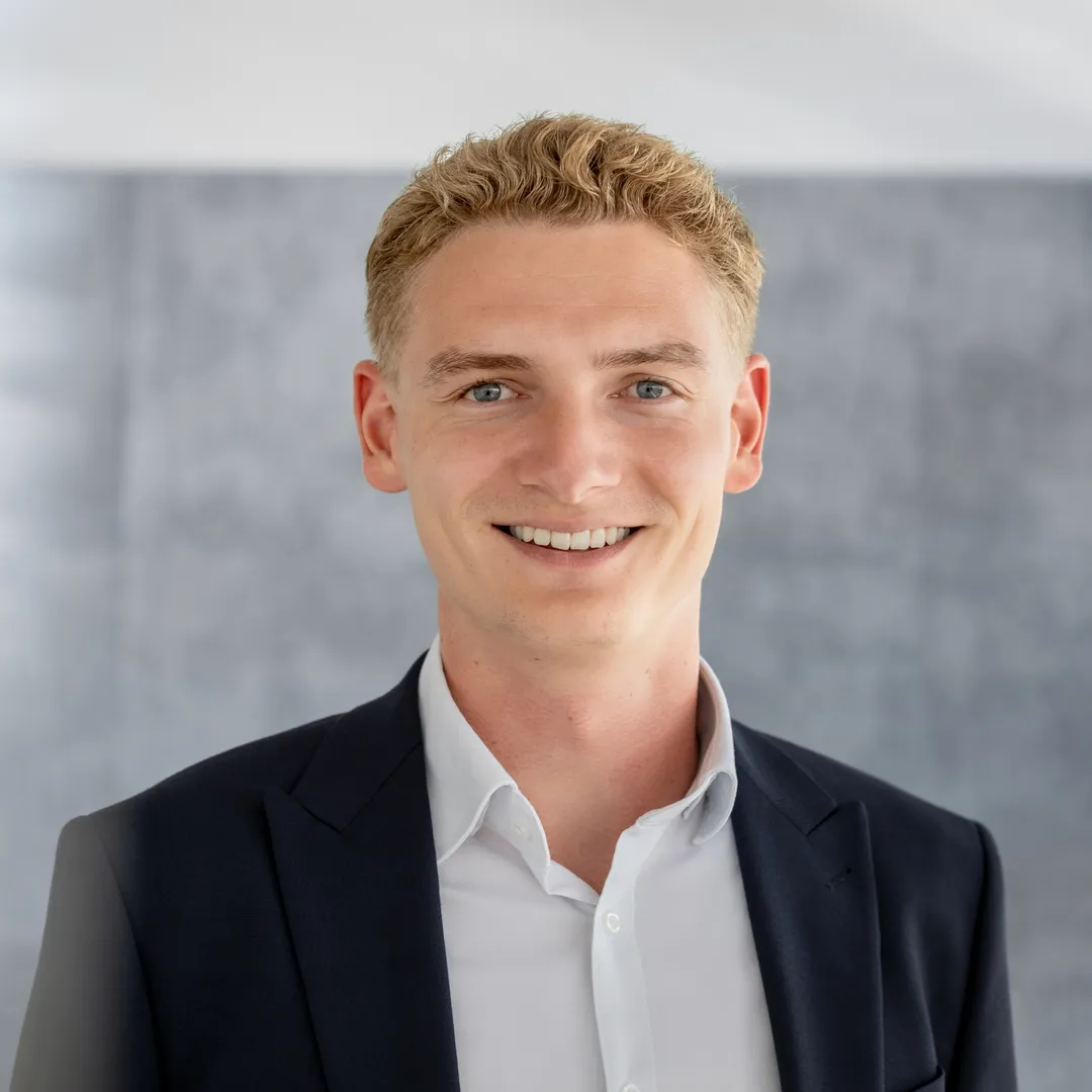 a man in a suit smiling