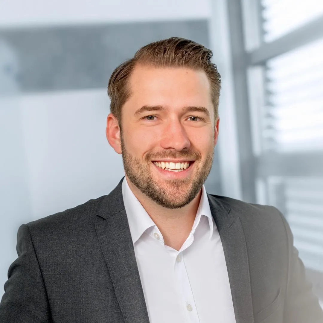 a man in a suit smiling