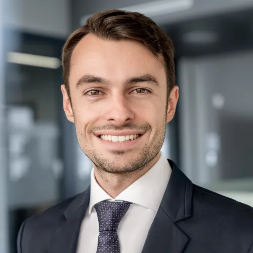 a man in a suit smiling