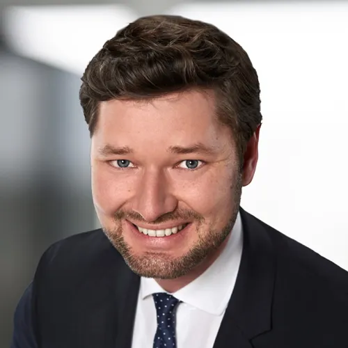 a man in a suit smiling