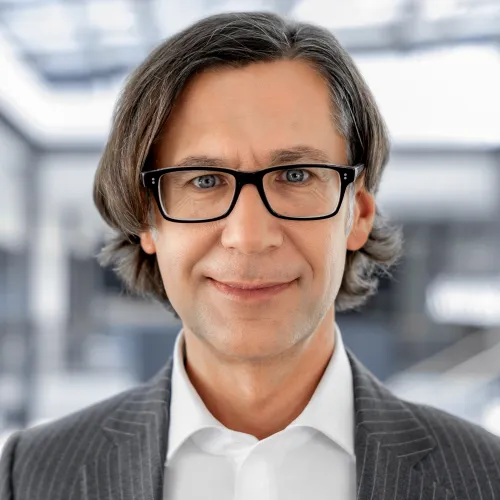 a man in a suit and glasses a man in a suit and glasses