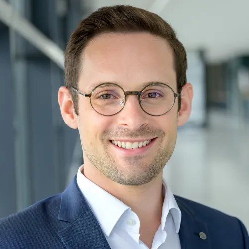 a man wearing glasses and smiling a man wearing glasses and smiling