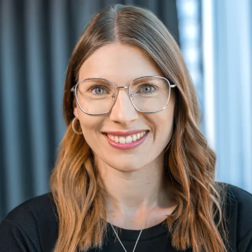 a woman wearing glasses and smiling a woman wearing glasses and smiling