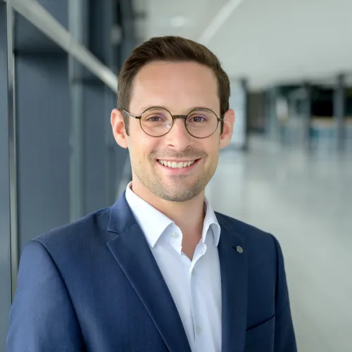a man wearing glasses and a suit a man wearing glasses and a suit