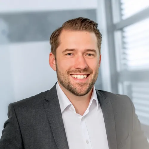 a man in a suit smiling