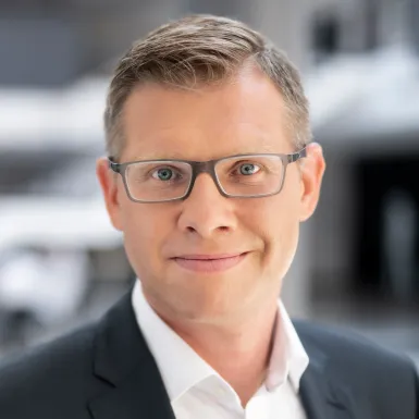 a man wearing glasses and a suit